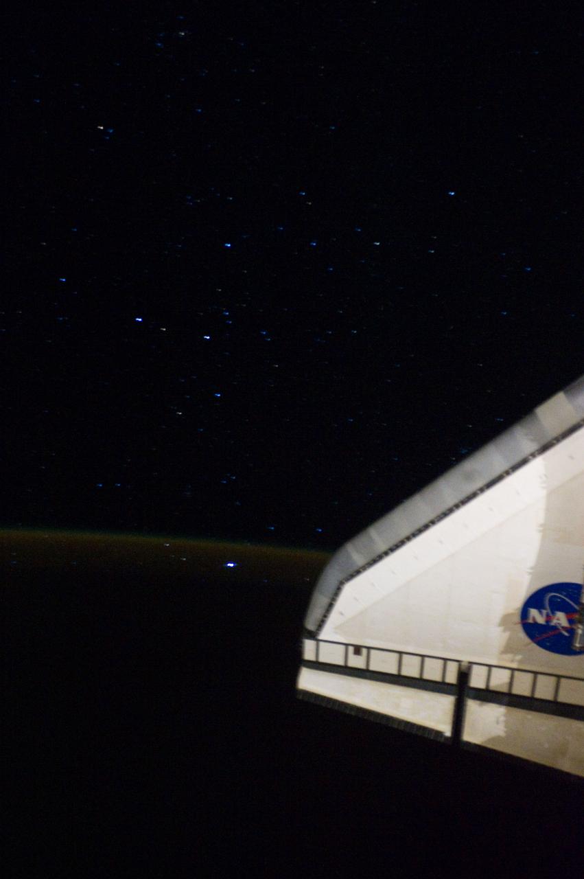 S134-E-009505 (27 May 2011) --- This is a view of the night sky of the Southern Hemisphere just off the port wing of Endeavour as the shuttle/space station tandem track northeastward over the South Atlantic Ocean about 1400 miles southeast of Rio de Janeiro, Brazil. The faint ?airglow? of the Earth?s atmosphere is visible just left of the wing. Photo credit: NASA