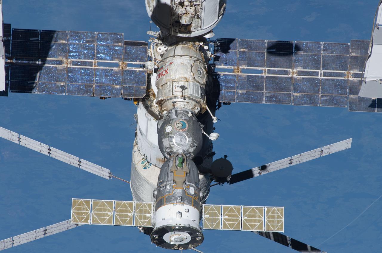 s134e010596 (May 30, 2011) --- A portion of the International Space Station's Russian segment is pictured with docked spacecraft including Europe's Automated Transfer Vehicle (ATV) and the Soyuz TMA-2 crew vehicle. The ATV is docked to the aft section of the Zvezda service module. The Soyuz is docked to the Poisk Mini-Research Module-2 which itself is attached to the forward section of Zvezda. At top center is a rear portion of the station's first module, the Zarya cargo module, which was placed into orbit Nov. 20, 1998.