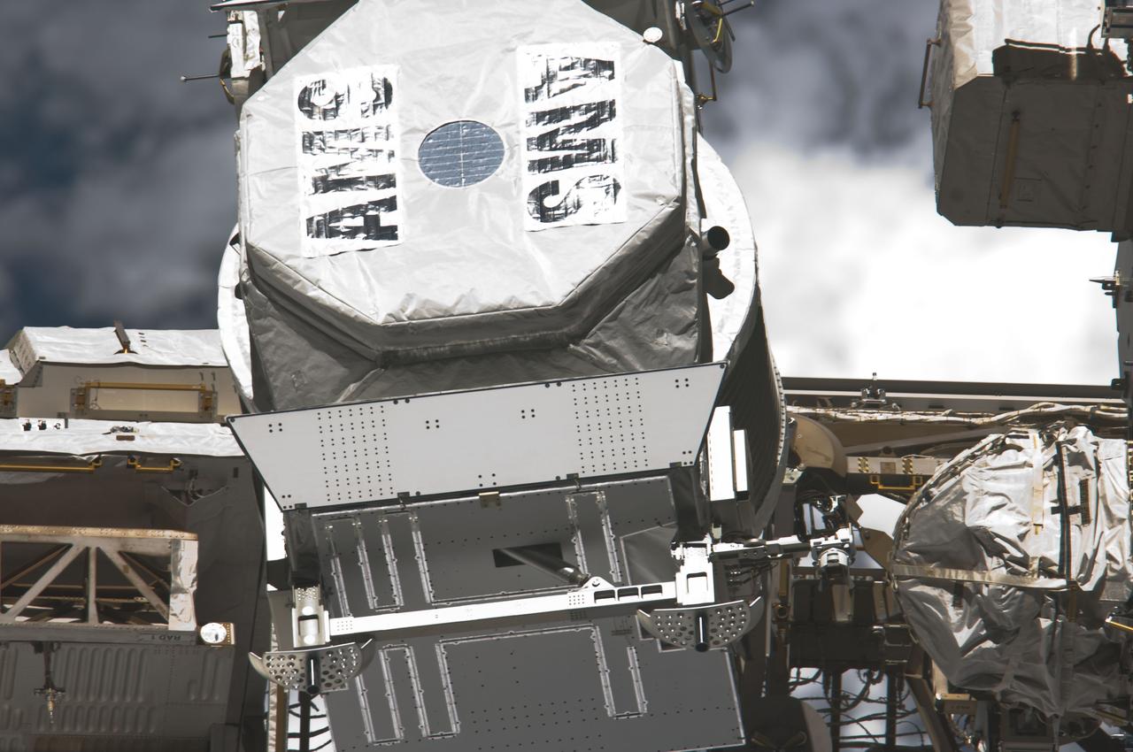 S134-E-010781 (30 May 2011) --- This image provides a close-up view of the Alpha Magnetic Spectrometer - 2 (AMS-2) photographed from inside the orbiter's cabin shortly after the space shuttle Endeavour undocked from the International Space Station (ISS) at the end of the STS-134 mission.  Photo credit: NASA