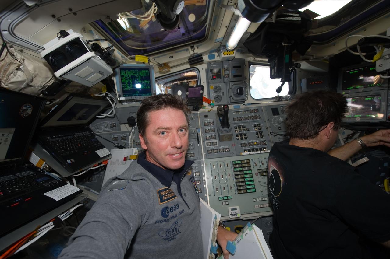 S134-E-010905 (30 May 2011) --- European Space Agency astronaut Roberto Vittori (left) and NASA astronaut Greg Chamitoff, both STS-134 mission specialists, are pictured on the aft flight deck of space shuttle Endeavour during flight day 15 activities. Photo credit: NASA