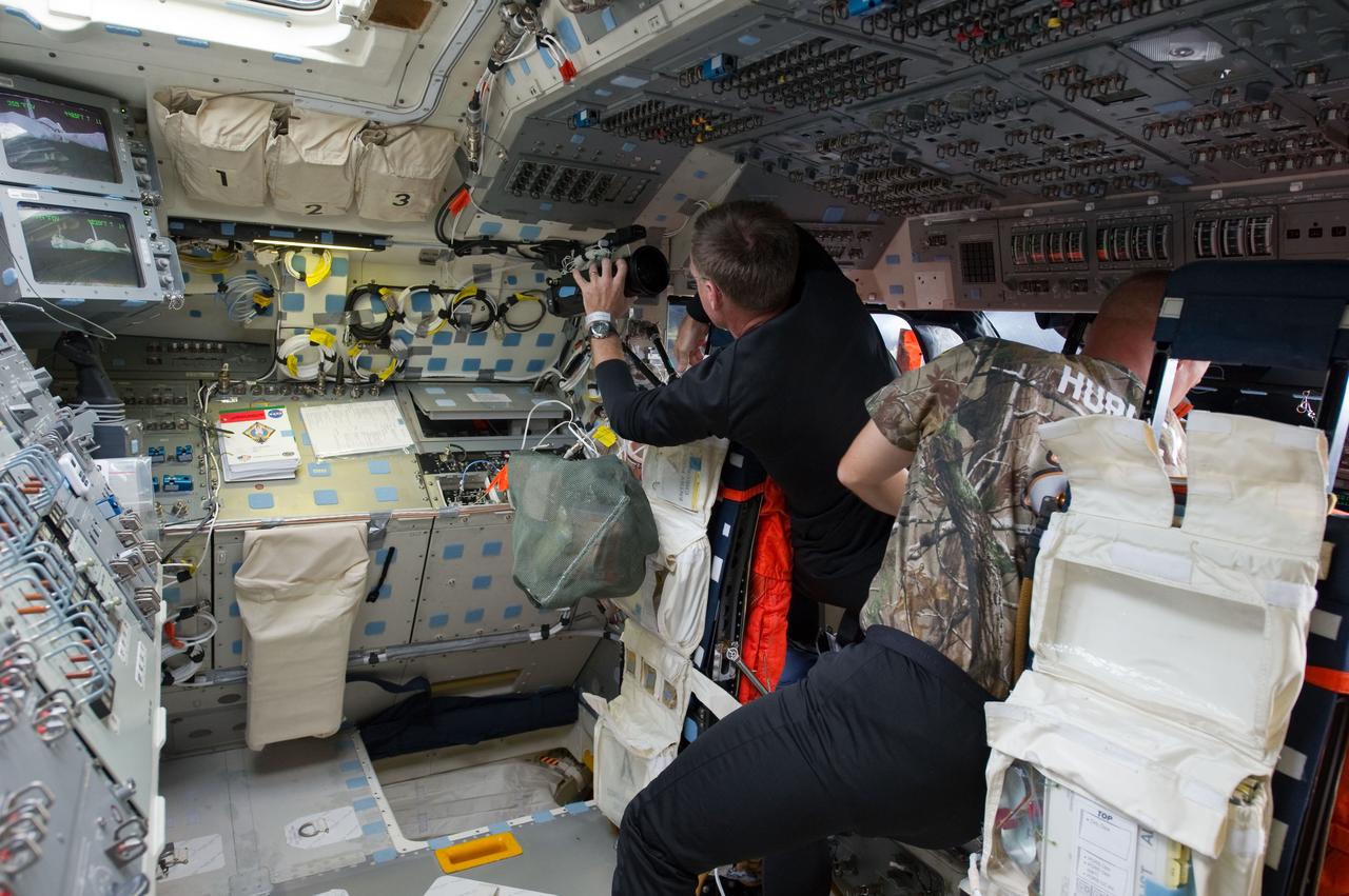 S135-E-006152 (8 July 2011) --- NASA astronauts Chris Ferguson, left, STS-135 commander, and Doug Hurley, pilot, are pictured on the flight deck of the space shuttle Atlantis during the mission's initial day of activities in Earth orbit. Photo credit: NASA