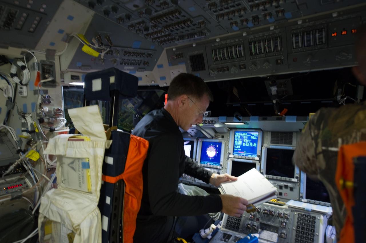 S135-E-006170 (8 July 2011) --- NASA astronaut Chris Ferguson, STS-135 commander, pilot, is pictured at the commander's station on the flight deck of the space shuttle Atlantis during the mission's initial day of activities in Earth orbit. Photo credit: NASA