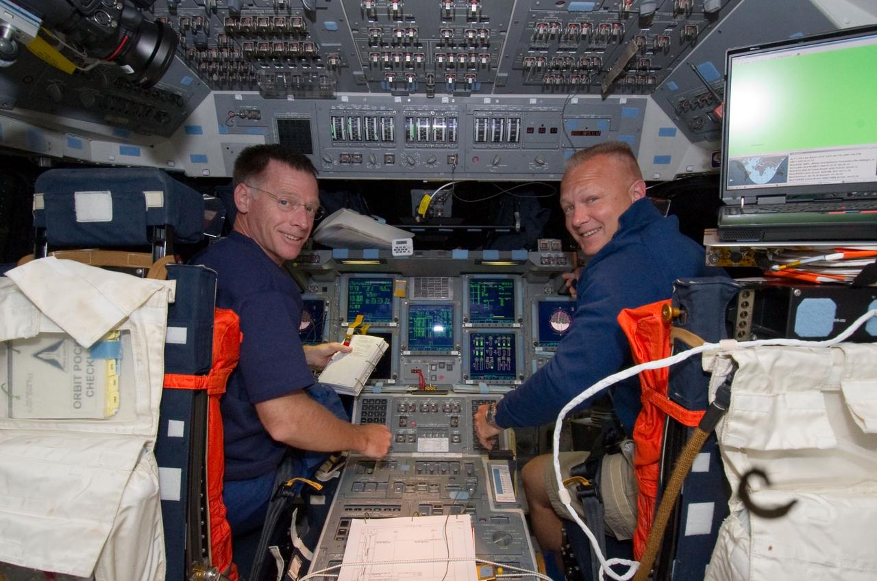S135-E-006297 (9 July 2011) --- NASA astronauts Chris Ferguson, left, and Doug Hurley are pictured at the commander's station and pilot?s station, respectively, on the flight deck of the space shuttle Atlantis during the mission's second day of activities in Earth orbit. Photo credit: NASA