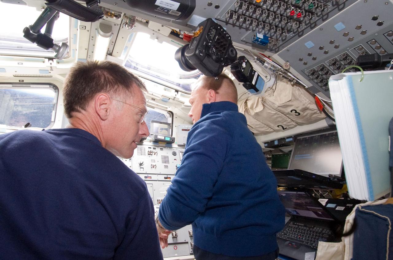S135-E-006309 (9 July 2011) --- NASA astronauts Chris Ferguson, STS-135 commander, and Doug Hurley, pilot, are pictured on the aft flight deck of the space shuttle Atlantis during the mission's second day of activities in Earth orbit. Photo credit: NASA