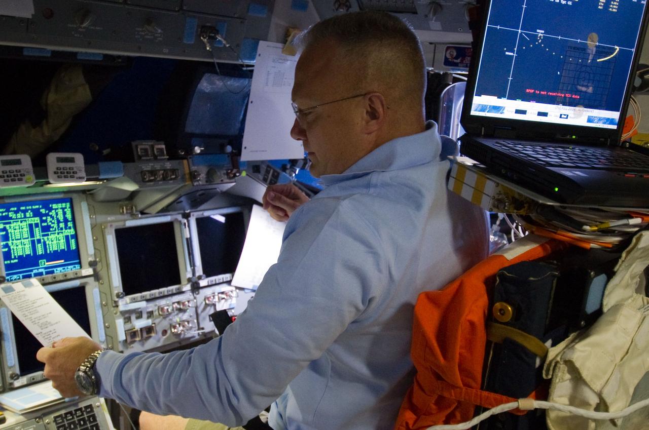 S135-E-007104 (10 July 2011) ? Astronaut Doug Hurley, STS-135 pilot, is pictured at the pilot's station on the flight deck of the space shuttle Atlantis during the mission?s third day in space. The photo was made by a crewmate shortly before the shuttle and the International Space Station docked. Photo credit: NASA