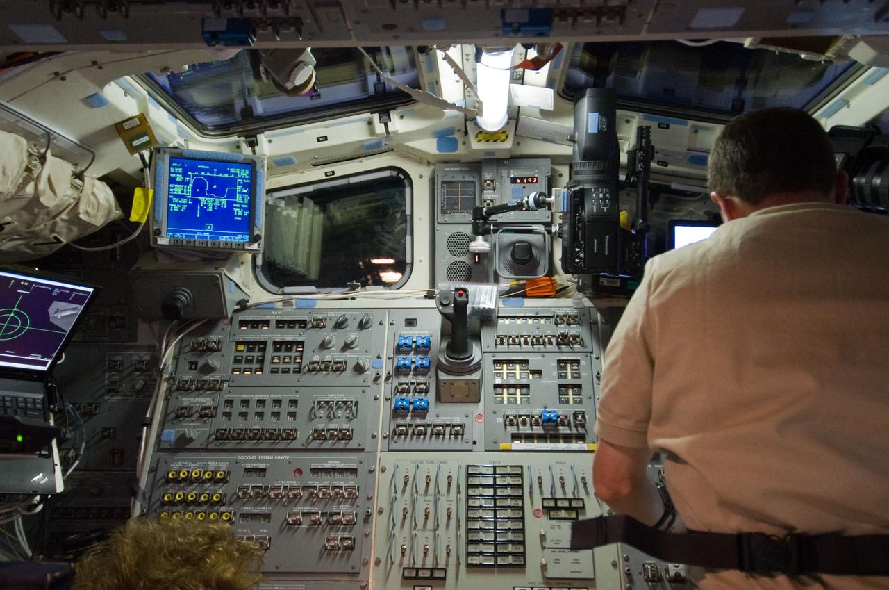 S135-E-007117 (10 July 2011) --- NASA astronaut Rex Walheim, STS-135 mission specialist, is pictured at a control panel on the aft flight deck of the space shuttle Atlantis during rendezvous and docking operations with the International Space Station. Photo credit: NASA