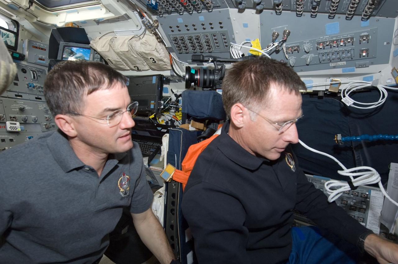 S135-E-007353 (11 July 2011) --- NASA astronauts Rex Walheim (left), STS-135 mission specialist, and Chris Ferguson are pictured on the forward flight deck the space shuttle Atlantis. The photo was taken during the mission's fourth day of activities in Earth orbit and second day while being docked with the International Space Station. Photo credit: NASA
