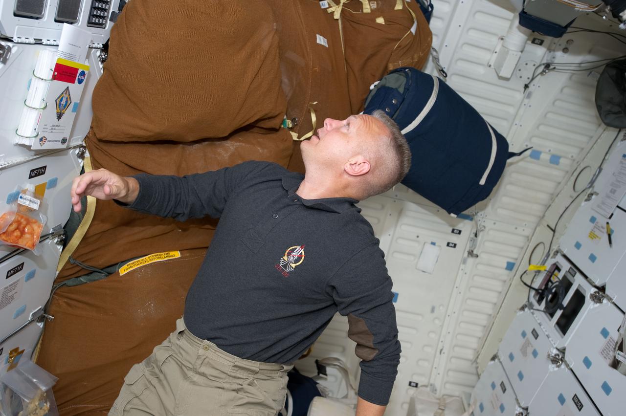 S135-E-007394 (11 July 2011) --- NASA astronaut Doug Hurley, STS-135 pilot, is pictured on the middeck of the space shuttle Atlantis during the mission's fourth day in space and second day docked with the International Space Station. Photo credit: NASA