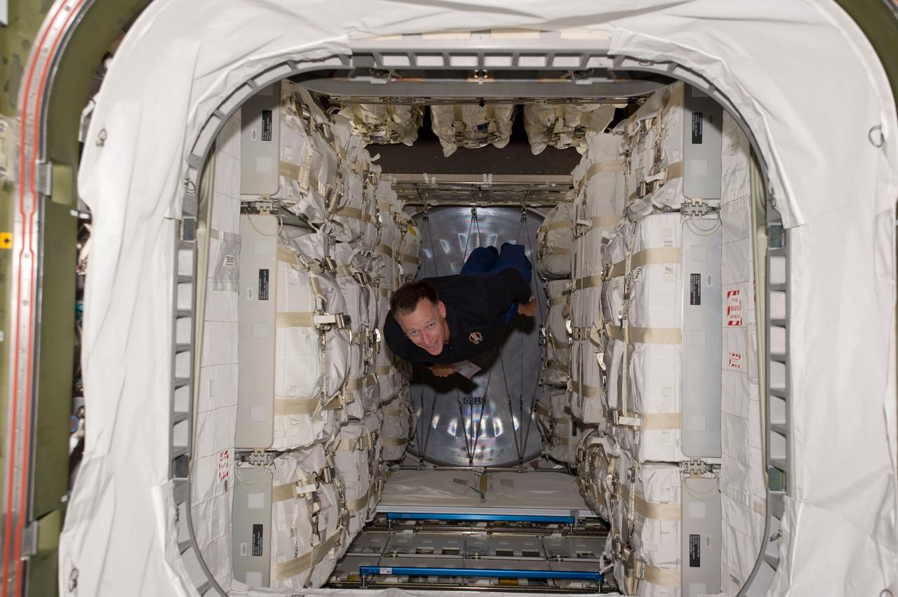 S135-E-007426 (11 July 2011) --- NASA astronaut Chris Ferguson, STS-135 commander, floats through the Raffaello multi-purpose logistics module packed with supplies and spare parts for the International Space Station. Ferguson and his three crewmates carried the module in Atlantis' cargo bay on their trip to link up with the orbital outpost.  Photo credit: NASA