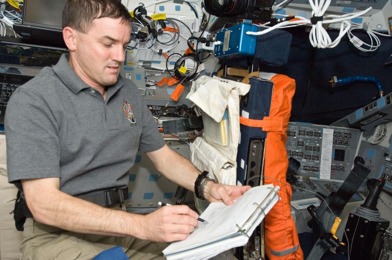 S135-E-007457 (11 July 2011) --- NASA astronaut Rex Walheim, STS-135 mission specialist, is pictured on the flight deck of the space shuttle Atlantis during the mission's fourth day of activities in Earth orbit and second day while being docked with the International Space Station. Photo credit: NASA