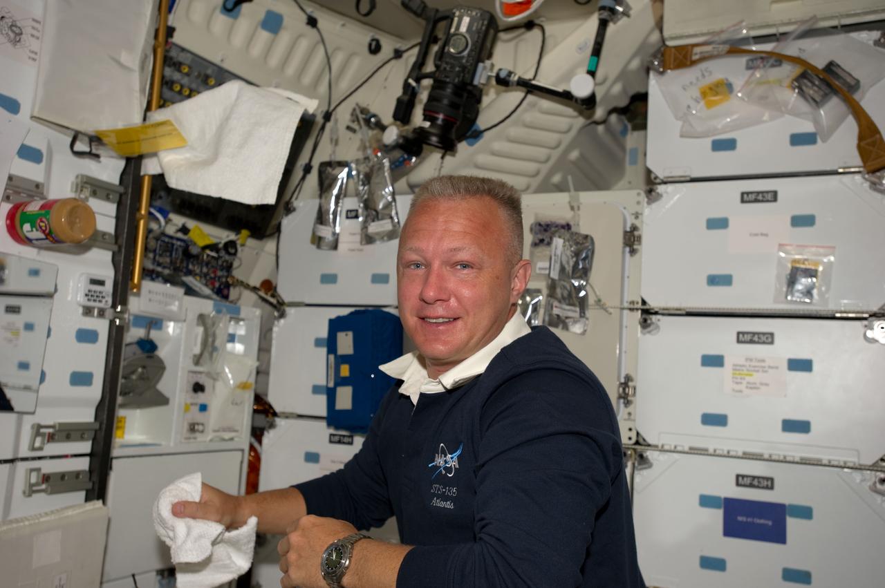 S135-E-007483 (12 July 2011) --- NASA astronaut Doug Hurley temporarily visits the middeck of the space shuttle Atlantis during spacewalk day on the International Space Station, July 12, 2011. The STS-135 pilot did not go outside the orbiting joint complex of shuttle and station, but he remained in the shirt-sleeved environment to provide important support to the two spacewalkers. Photo credit: NASA