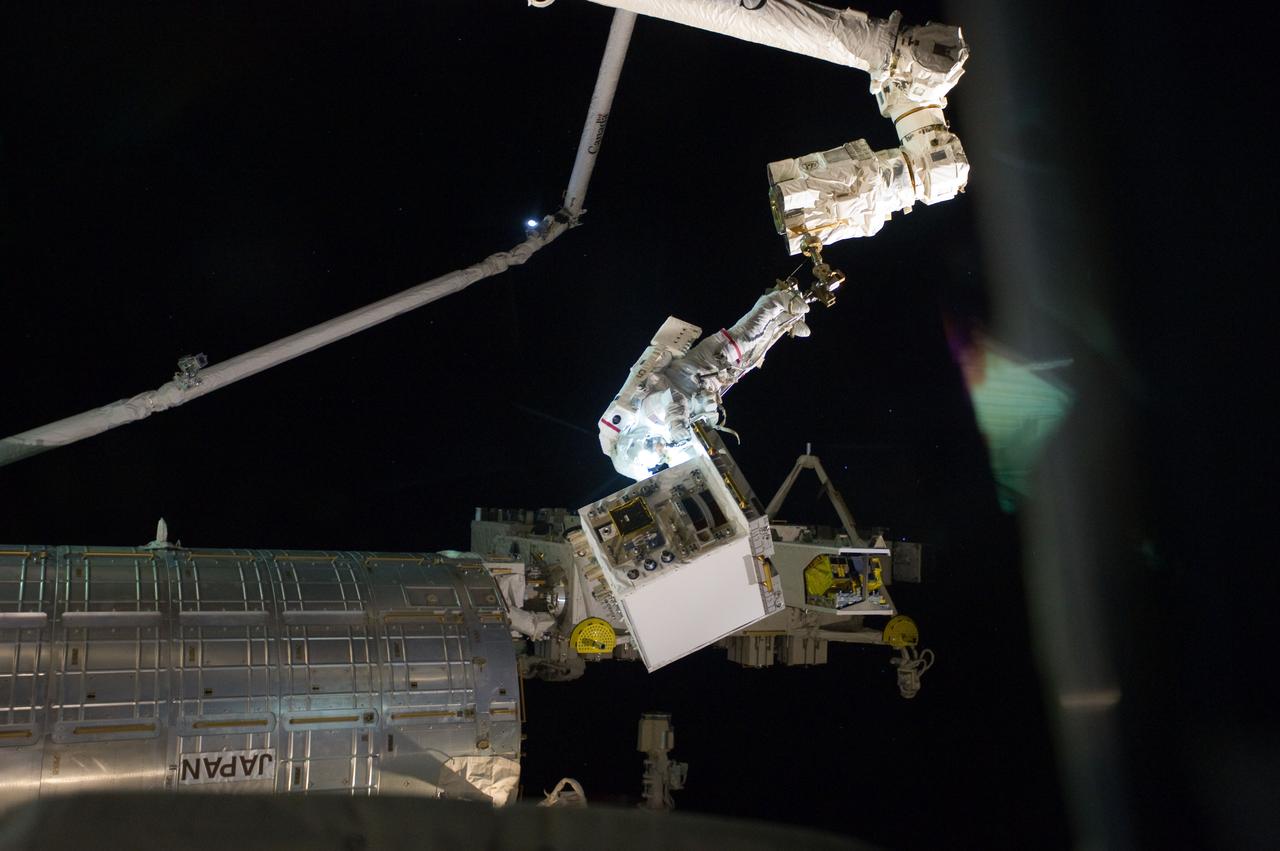 S135-E-007535 (12 July 2011) --- With his feet secured on a restraint on the space station remote manipulator system’s robotic arm or Canadarm2, NASA astronaut Mike Fossum, is holds the Robotics Refueling Mission payload, which was the focus of one of the primary chores accomplished on a six and a half hour spacewalk on July 12. NASA astronaut Ron Garan, also a station flight engineer, who shared the spacewalk with Fossum, is out of frame. Photo credit: NASA