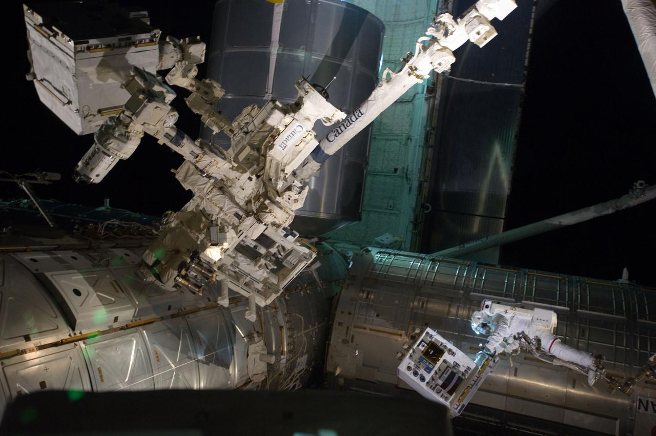 S135-E-007544 (12 July 2011) --- With his feet secured on a restraint on the space station remote manipulator system's robotic arm or Canadarm2, NASA astronaut Mike Fossum (lower right side of frame) holds the Robotics Refueling Mission payload, which was the focus of one of the primary chores accomplished on a six and a half hour spacewalk on July 12.   The failed pump module is with DEXTRE in the upper left corner of the photo.  NASA astronauts Fossum and Ron Garan performed the six-hour, 31-minute spacewalk, which represents the final scheduled extravehicular activity during shuttle missions.  Photo credit: NASA