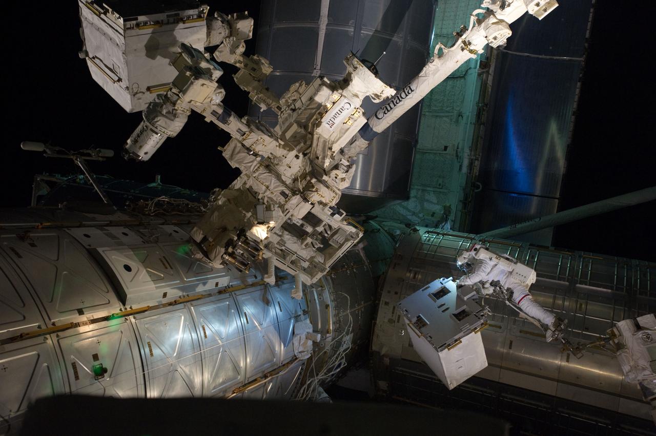 S135-E-007551 (12 July 2011) --- With his feet secured on a restraint on the space station remote manipulator system's robotic arm or Canadarm2, NASA astronaut Mike Fossum (lower right side of frame) holds the Robotics Refueling Mission payload, which was the focus of one of the primary chores accomplished on a six and a half hour spacewalk on July 12.   The failed pump module is with DEXTRE in the upper left corner of the photo.  NASA astronauts Fossum and Ron Garan performed the six-hour, 31-minute spacewalk, which represents the final scheduled extravehicular activity during shuttle missions.  Photo credit: NASA