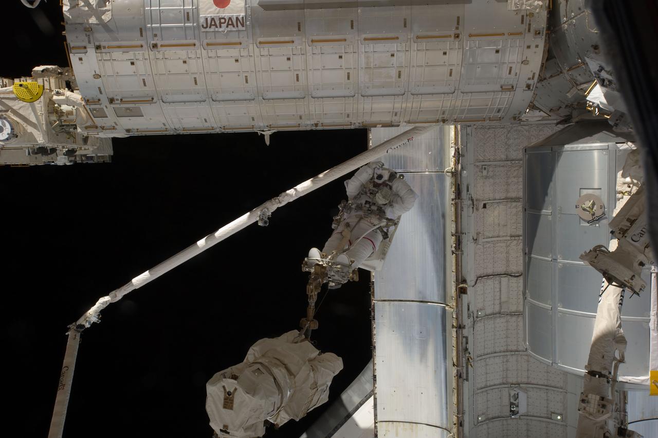 S135-E-007595 (12 July 2011) --- With the space shuttle Atlantis as a backdrop, and restrained on the end of the space station remote manipulator system or Canadarm2, NASA astronaut Mike Fossum takes a picture during a July 12 spacewalk. Fossum and NASA astronaut Ron Garan spent just a little over six and a half hours on their various tasks. The Kibo module of Japan's Aerospace Exploration Agency or JAXA, is at top frame. Photo credit: NASA
