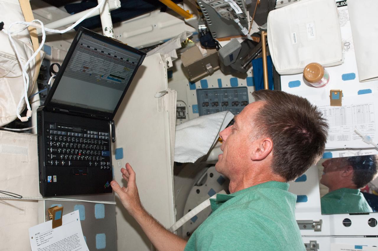 S135-E-007705 (13 July 2011) --- NASA astronaut Chris Ferguson, STS-135 commander, inputs data on a computer on Atlantis' middeck during the sixth day in space for him and three crewmates. Photo credit: NASA