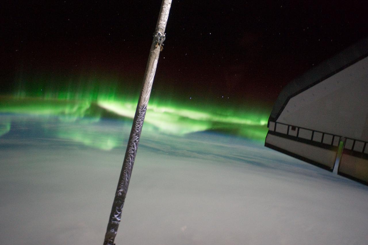 S135-E-007744 (14 July 2011) --- One of the STS-135 Atlantis crewmembers took this photo of the Southern Lights or Aurora Australis while visiting the International Space Station on July 14, 2011. Part of the orbiter boom sensor system (OBSS) is seen, as it was attached on the end of the shuttle's robotic arm (out of frame). A part of the port side wing of the shuttle is at right. Photo credit: NASA