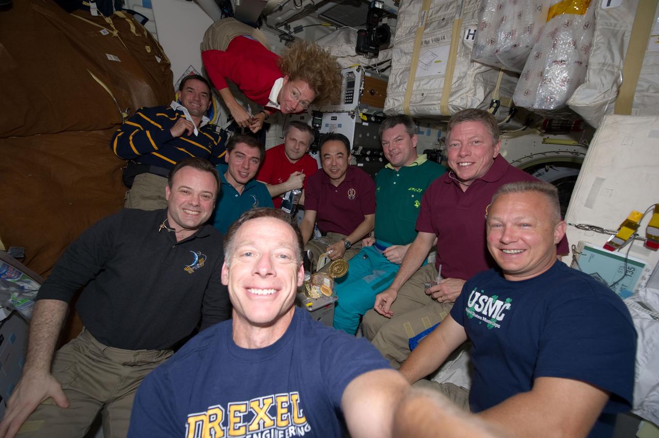 S135-E-007806 (14 July 2011) --- Seven  astronauts ? six from NASA and one from the Japan Aerospace Exploration Agency (JAXA) ? and three Russian  cosmonauts participate on July 14, 2011 in a special meal on the Space Shuttle Atlantis' middeck.  One of the final meals shared between shuttle and station crews has been called  ?The  All-American Meal.?   The STS-135 crew consists of NASA astronauts Chris Ferguson, Doug Hurley, Sandy Magnus and Rex Walheim; the  Expedition 28 or station crew members are  JAXA astronaut Satoshi Furukawa, NASA astronauts Ron Garan and Mike Fossum, and Russian cosmonauts Andrey  Borisenko, Alexander  Samokutyaev  and  Sergei Volkov.  Note: Ferguson is barely in the frame at bottom foreground.  Photo credit: NASA