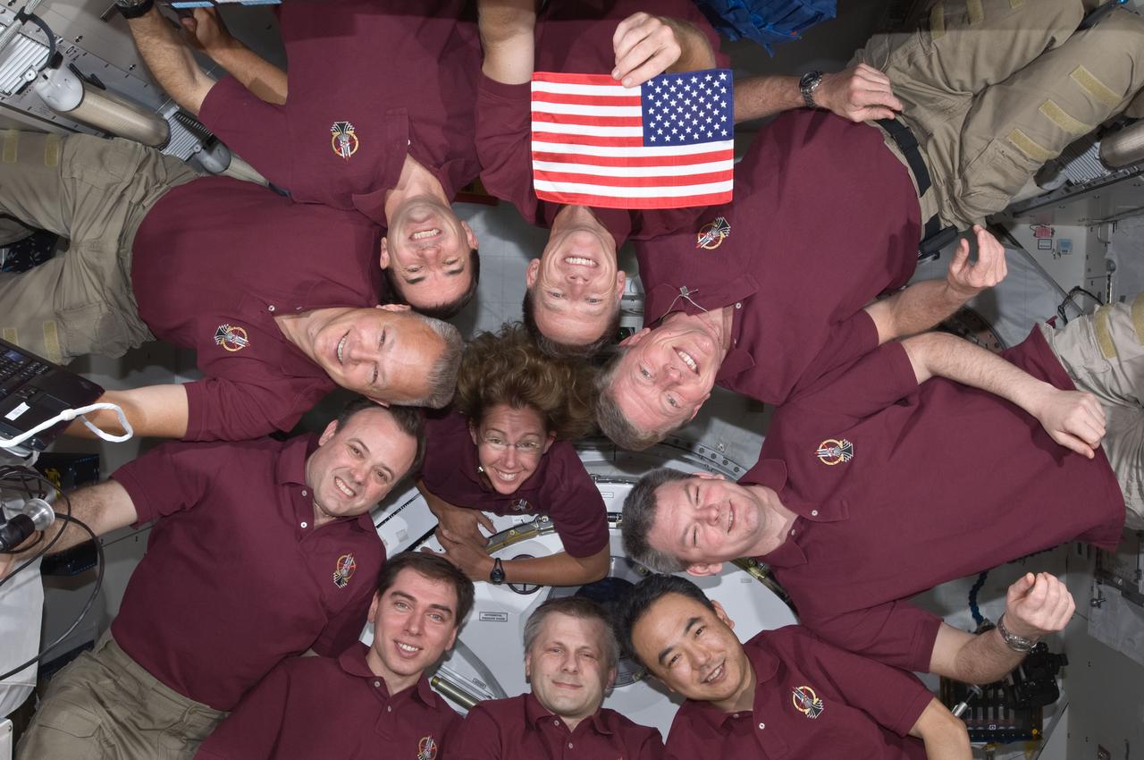 S135-E-008059 (15 July 2011) --- In an occurrence which became somewhat of a tradition for shuttle crews and those of the International Space Station expeditions, the Expedition 28 crew and the STS-135 Atlantis astronauts formed a microgravity circle for a portrait aboard the orbiting complex's Kibo laboratory of the Japan Aerospace Exploration Agency. The STS-135 crew consists of NASA astronauts Chris Ferguson, Doug Hurley, Sandy Magnus and Rex Walheim; the Expedition 28  crewmembers are JAXA astronaut Satoshi Furukawa, NASA astronauts Ron Garan and Mike Fossum, and Russian cosmonauts Andrey Borisenko, Alexander Samokutyaev and Sergei Volkov.  Shuttle and station commanders Ferguson and Borisenko are in the 12 o'clock and six o'clock positions, respectively, on the circle. The U.S. flag pictured was flown on the first space shuttle mission, STS-1, and flew on this mission to be presented to the space station crew. It will remain onboard until the next crew launched from the U.S. will retrieve it for return to Earth. It will fly from Earth again, with the crew that launches from the U.S. on a journey of exploration beyond Earth orbit.  Photo credit: NASA