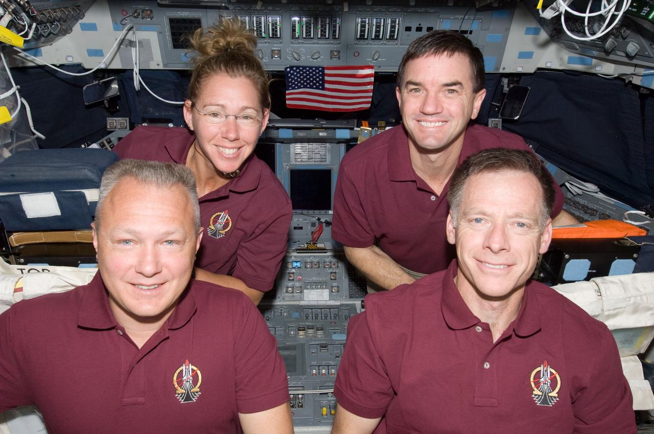 S135-E-008715 (16 July 2011) --- The four crew members of the Atlantis STS-135 mission pose for a picture on the spacecraft's flight deck.  On the front row are NASA astronauts Doug Hurley (left) and Chris Ferguson, pilot and commander respectively. In the rear are NASA astronauts Sandy Magnus and Rex Walheim, both mission specialists. The U.S. flag pictured was flown on the first space shuttle mission, STS-1, and flew on this mission to be presented to the space station crew. It will remain onboard the station until the next crew launched from the U.S. will retrieve it for return to Earth. It will fly from Earth again, with the crew that launches from the U.S. on a journey of exploration beyond Earth orbit. Photo credit: NASA