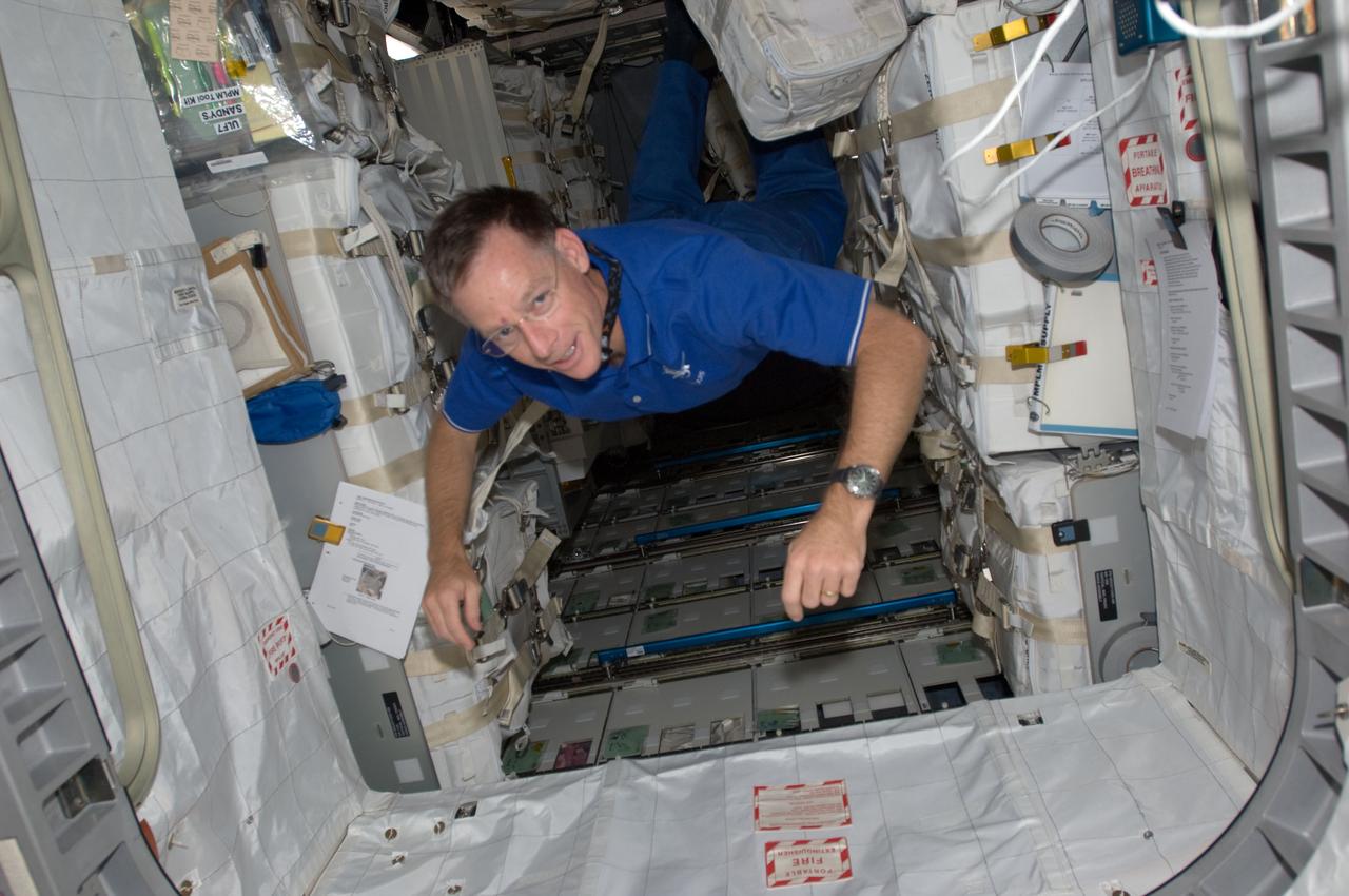 S135-E-008851 (17 July 2011) --- This image shows NASA astronaut Chris Ferguson, STS-135 commander, in the Raffaello multi-purpose logistics module. The photo serves as the "after" shot following a great amount of work by joint crews from Atlantis and the International Space Station to transfer supplies to and from the two spacecraft. Approximately a week earlier Ferguson posed for the "before" version.  Photo credit: NASA