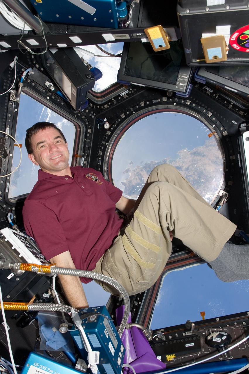 S135-E-009344 (18 July 2011) --- NASA astronaut Rex Walheim, STS-135 mission specialist, takes an opportunity to get the best view of Earth from aboard the International Space Station as he moves inside the Cupola. Walheim and three crewmates were in the last hours of their stay of over one week onboard the orbiting complex. Photo credit: NASA