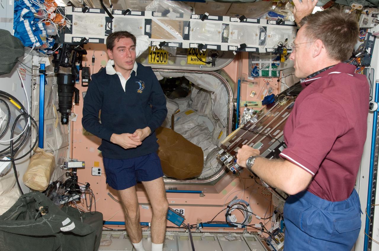 S135-E-009499 (18 July 2011) --- Inside the International Space Station's Node 1 or Unity, NASA astronaut Chris Ferguson (right), STS-135 commander, talks with Russian cosmonaut Sergei Volkov, Expedition 28 flight engineer, on the final day of joint activities involving the station and space shuttle Atlantis crews. Photo credit: NASA