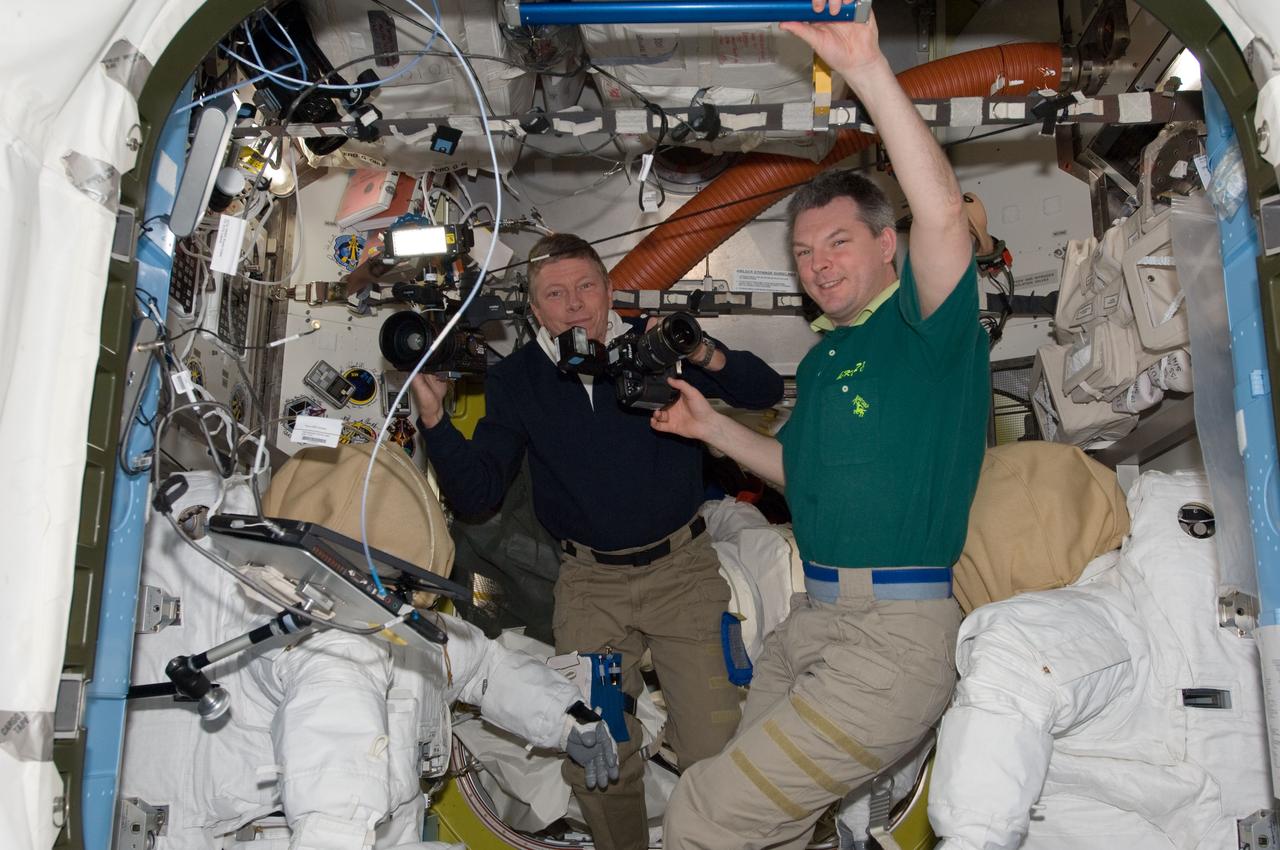 S135-E-009507 (18 July 2011) --- In the Quest airlock of the International Space Station, NASA astronaut Mike Fossum (left) and Russian cosmonaut Alexander Samokutyaev, both Expedition 28 flight engineers, check out an electronic still camera. A little over a week ago, Fossum and crewmate NASA astronaut Ron Garan began and ended an historic spacewalk in the airlock. Photo credit: NASA