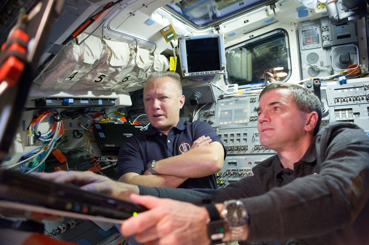 S135-E-010688 (19 July 2011) --- NASA astronauts Doug Hurley (left), pilot for the STS-135 mission and Rex Walheim, mission specialist, are pictured on the flight deck of the space shuttle Atlantis prior to undocking/ separation from the International Space Station. Photo credit: NASA