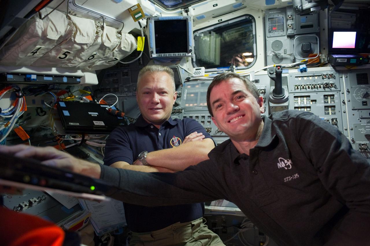 S135-E-010689 (19 July 2011) --- NASA astronauts Doug Hurley (left), pilot for the STS-135 mission and Rex Walheim, mission specialist, are pictured on the flight deck of the space shuttle Atlantis prior to undocking/ separation from the International Space Station. Photo credit: NASA