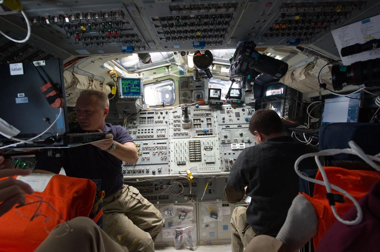 S135-E-010699 (19 July 2011) --- NASA astronauts Doug Hurley (left), pilot for the STS-135 mission and Rex Walheim, mission specialist, are pictured on the flight deck of the space shuttle Atlantis prior to undocking/ separation from the International Space Station. Photo credit: NASA