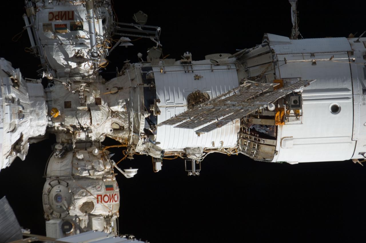s135e011242 (July 19, 2011) --- The International Space Station's Zvezda service module is pictured with two Russian modules attached to its forward section. Both modules host docked Russian spacecraft including the Progress resupply ships and the Soyuz crew ships. At top left is the Pirs Docking Compartment where Russian spacewalks are staged. At bottom left is the Poisk Mini-Research Module-2 where Russian science experiments are conducted.