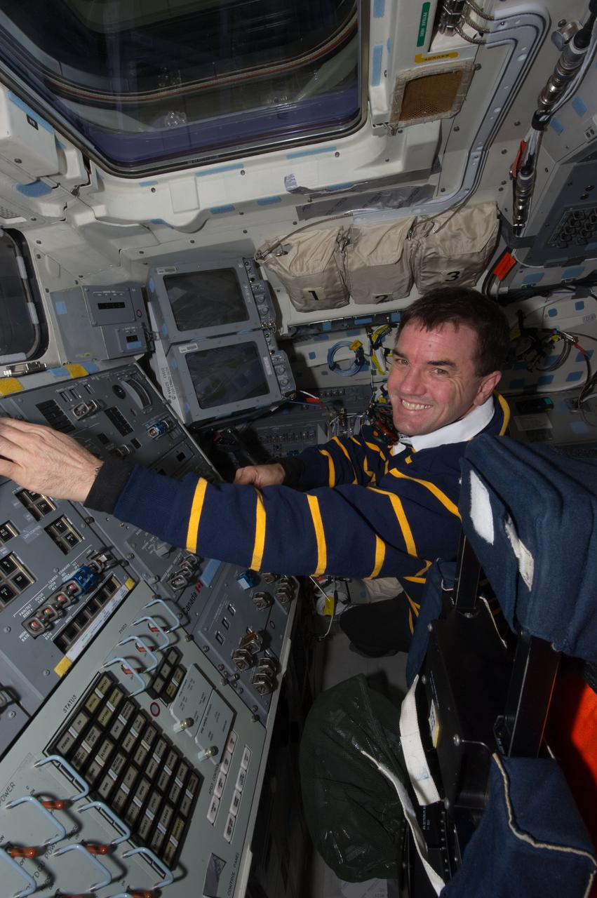 S135-E-012383 (21 July 2011) --- Astronaut Rex Walheim, STS-135 mission specialist, makes preparations on space shuttle Atlantis' aft flight deck for the mission's re-entry phase and the final landing of a NASA space shuttle.  Photo credit: NASA