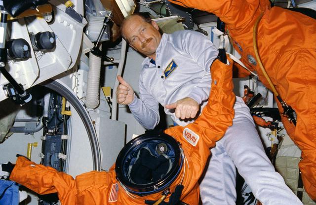 NASA image: STS-26 Commander Hauck with launch and entry suits (LESs) on OV-103's middeck