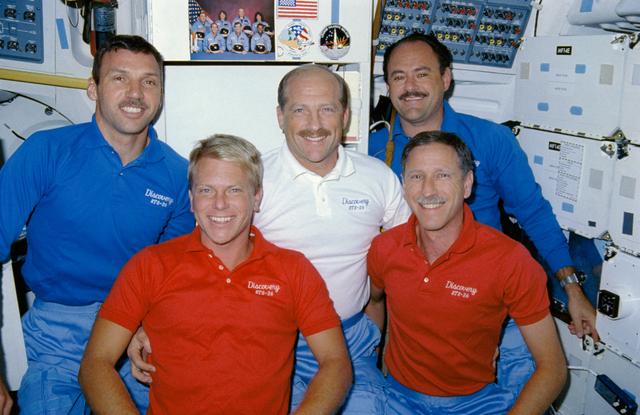 STS-26 crewmembers pose for onboard portrait on middeck with 51L mementos
