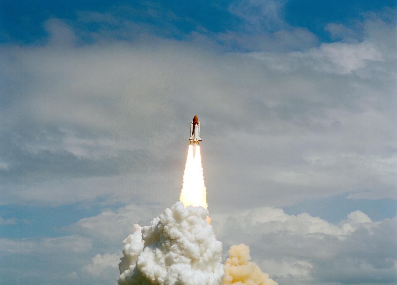 STS-26 Discovery, Orbiter Vehicle (OV) 103, rises into a cloudy sky and heads for Earth orbit atop the external tank (ET) as exhaust plumes billow from the two solid rocket boosters (SRBs) during liftoff from Kennedy Space Center (KSC) Launch Complex (LC) pad 39B. STS-26 marks OV-103's first flight since September 1985 and NASA's first manned mission since 51L Challenger accident, 01-28-86.