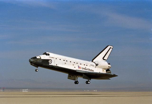 NASA image: STS-26 Discovery, OV-103, with landing gear deployed glides above EAFB runway