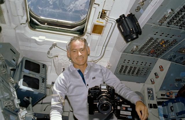 NASA image: STS-27 MS Mullane on aft flight deck with camera equipment