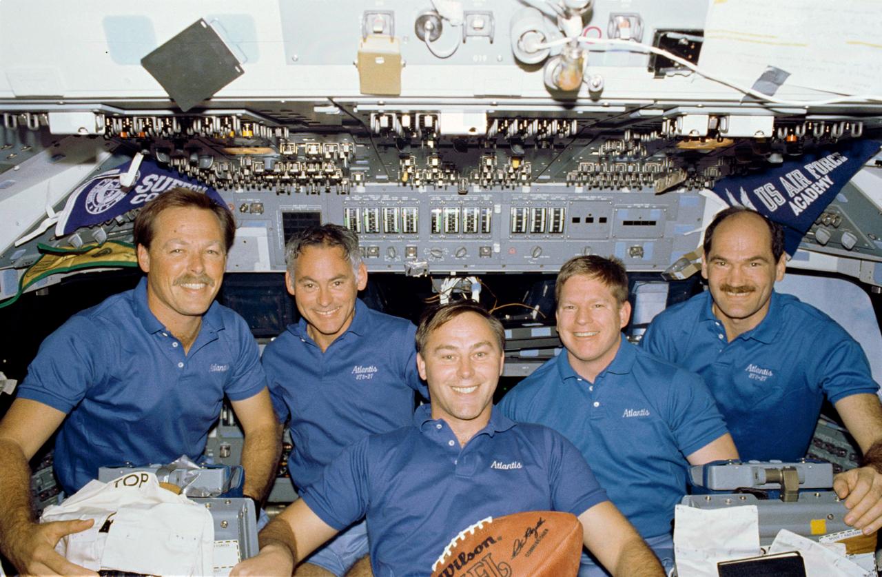 STS027-11-012 (2-6 Dec. 1988) --- The crew members for the STS-27 space flight pose on the flight deck of the Earth-orbiting space shuttle Atlantis with a football free-floating in the foreground. Left to right are astronauts Robert L. Gibson, commander; Richard M. (Mike) Mullane, Jerry L. Ross and William M. Shepherd, mission specialists; and Guy S. Gardner, pilot. The football was later presented to the National Football League (NFL) at halftime of the Super Bowl in Miami. Photo credit: NASA