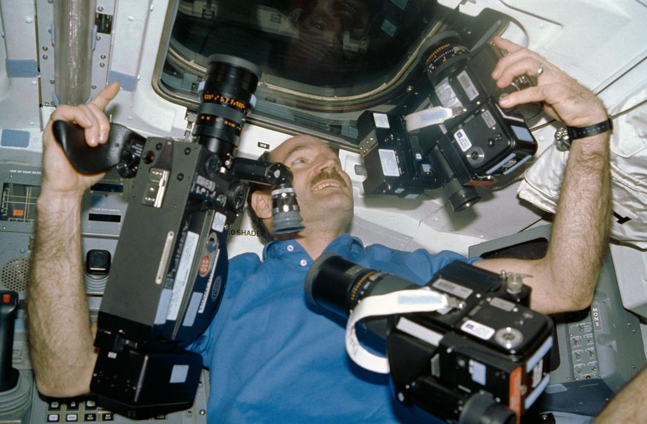 STS027-14-021 (2-6 Dec. 1988) --- Astronaut Guy S. Gardner, STS-27 pilot, appears to have enough cameras as he prepares to take photographs onboard the Earth-orbiting space shuttle Atlantis. Photo credit: NASA