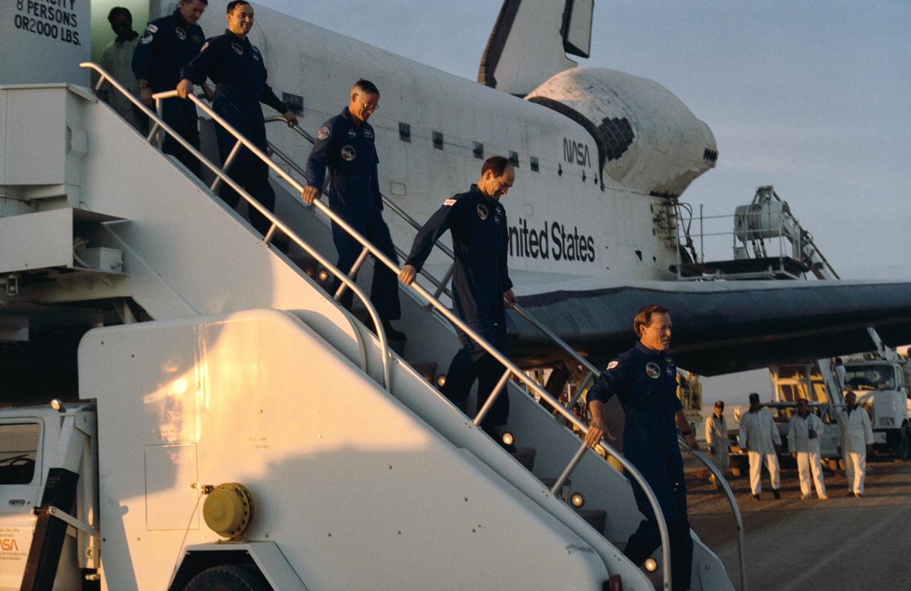 STS027-S-020 (6 Dec 1988) --- The five astronauts who were aboard Atlantis for its return to flight leave their spacecraft after almost 4 1/2 days in space. From bottom to top are Astronauts Robert L. Gibson, mission commander; Guy S. Gardner, pilot; and Richard M. (Mike) Mullane, Jerry L. Ross and William M. Shepherd, mission specialists. Atlantis touched down on Rogers Dry Lake Bed at 3:36 p.m. (PST), Dec. 6, 1988.