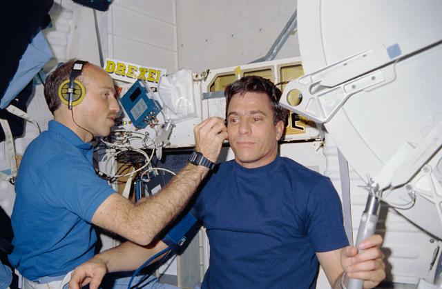NASA image: STS-29 Pilot Blaha has blood flow checked by MS Bagian on OV-103's middeck