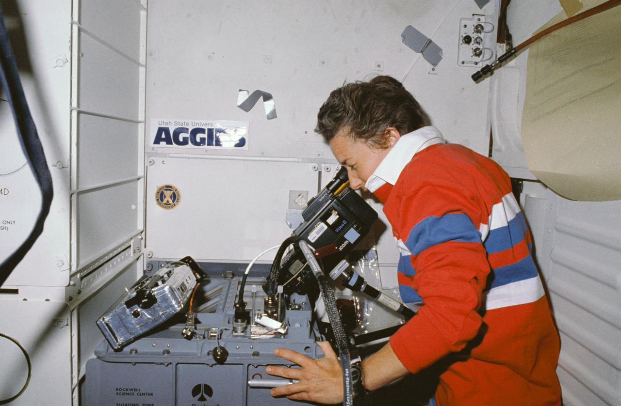 STS030-10-002 (8 May 1989) --- STS-30 Mission Specialist Mary L. Cleave operates 8mm video camcorder at Fluids Experiment Apparatus 2 (FEA-2) (SK73-000102) unit located in aft middeck locker onboard Atlantis, Orbiter Vehicle (OV) 103. Two 8mm video camcorders are positioned above FEA-2 unit to record experiment titled "Floating Zone Crystal Growth and Purification". Rockwell International (RI) through its Space Transportation Systems Division, Downey, California, is engaged in a joint endeavor agreement (JEA) with NASA's Office of Commercial Programs in the field for floating zone crystal growth research. Utah State University Aggies decal appears on aft bulkhead above FEA-2 unit.