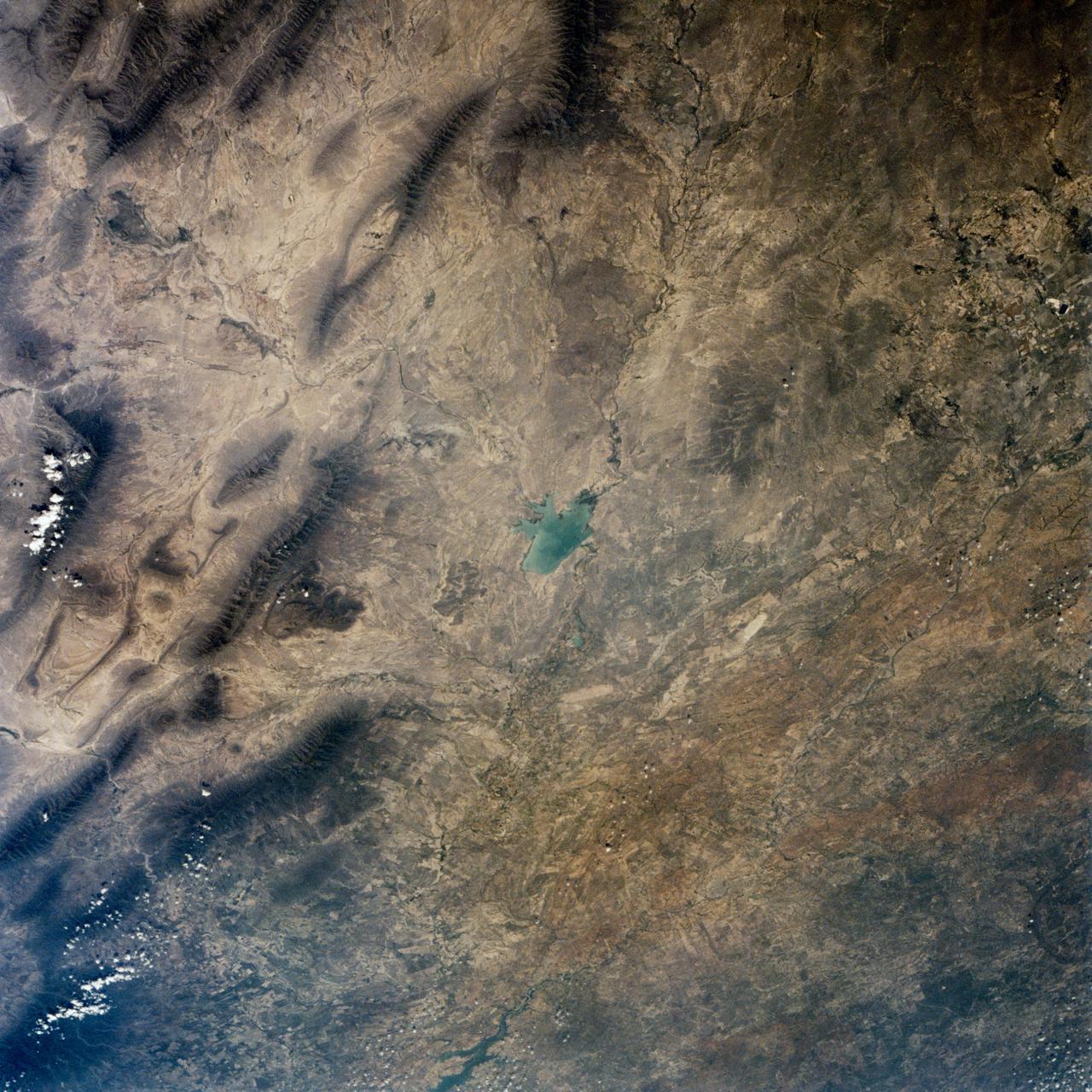 This is a single scene from a pair (frames 021 & 024) to study the effects of polarized light in Earth Observations. One scene was exposed with vertically polarized light, the other, horizontally. The subject in this study, is a lake behind Presa (dam) Don Martin (27.5N, 100.5W) on thge edge of the Rio Grande Plain near it's boundry with the Sierra Madre Oriental in Coahuila, Mexico.