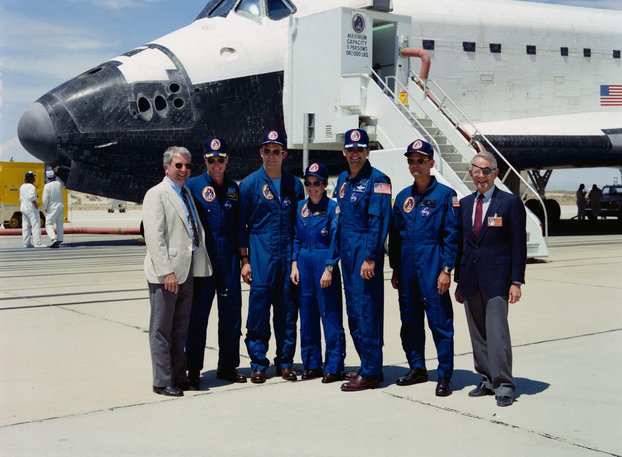 STS030-S-129 (8 May 1989) --- Astronaut crew members who manned the Space Shuttle Atlantis for just over four days pose with NASA officials following the safe landing of their spacecraft (which forms the backdrop for the picture).  Left to right are Rear Admiral Richard H. Truly, acting NASA Administrator; astronauts David M. Walker, Mark C. Lee, Mary L. Cleave, Ronald J. Grabe and Norman E. Thagard; and Dale D. Myers, NASA Deputy Administrator.