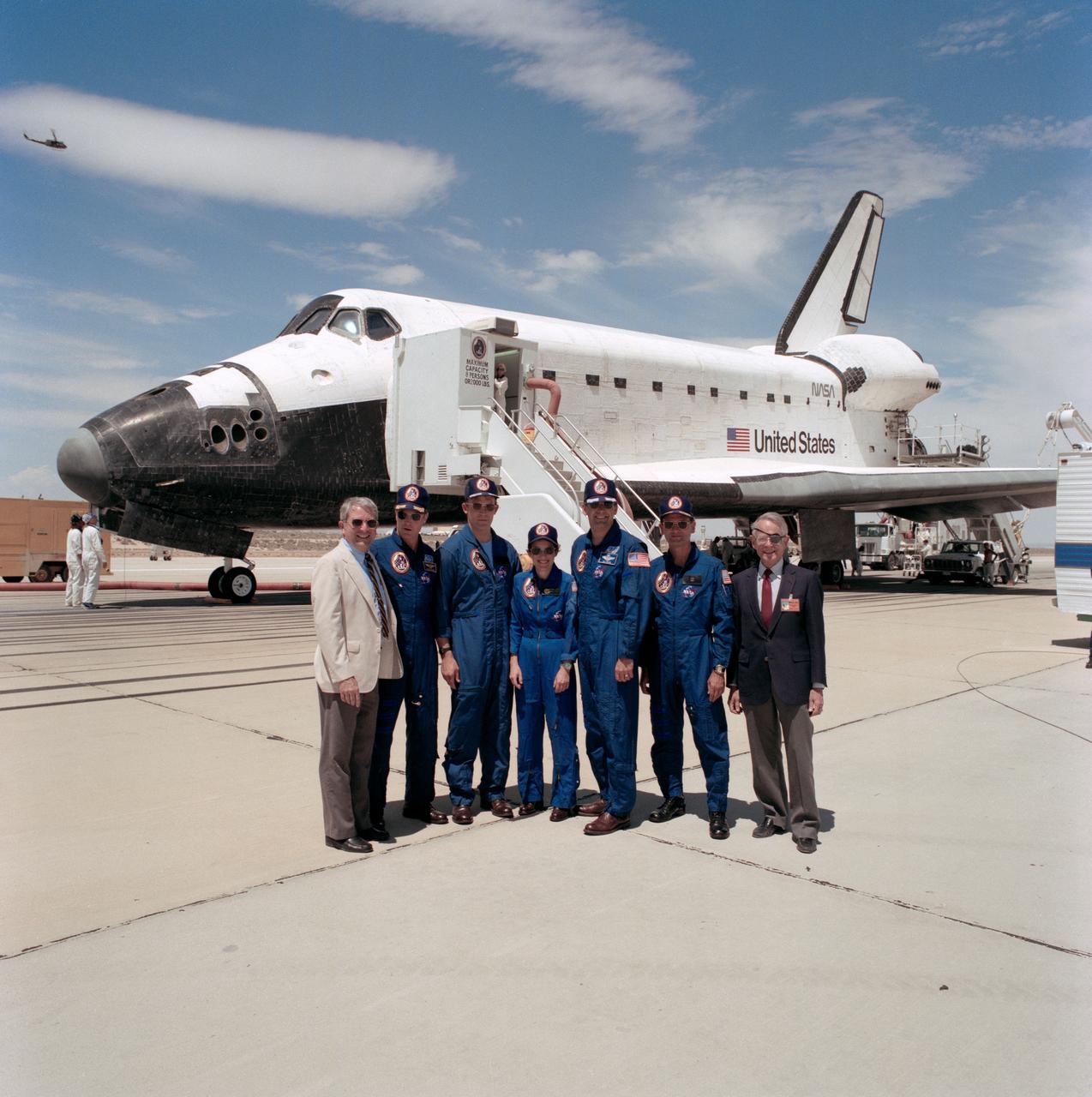STS030-S-130 (8 May 1989) --- Astronaut crew members who manned the Space Shuttle Atlantis for just over four days pose with NASA officials following the safe landing of their spacecraft (which forms the backdrop for the picture). Left to right are Rear Admiral Richard H. Truly, acting NASA Administrator; astronauts David M. Walker, Mark C. Lee, Mary L. Cleave, Ronald J. Grabe and Norman E. Thagard; and Dale D. Myers, NASA Deputy Administrator.