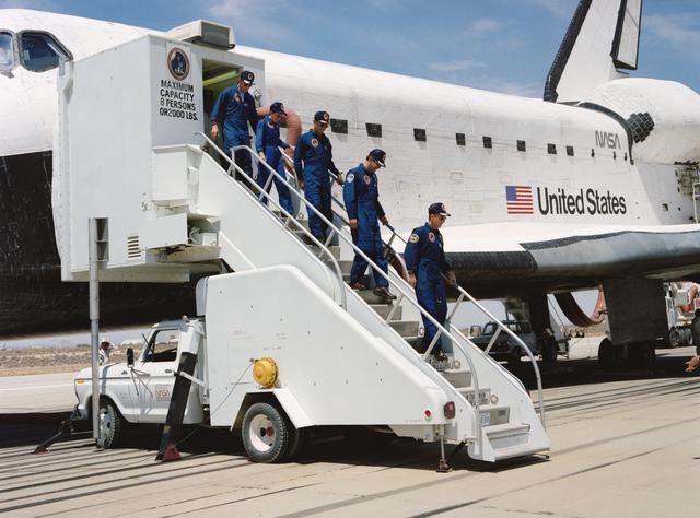 NASA image: STS-30 crew egresses OV-104 via stairway at Edwards Air Force Base (EAFB)