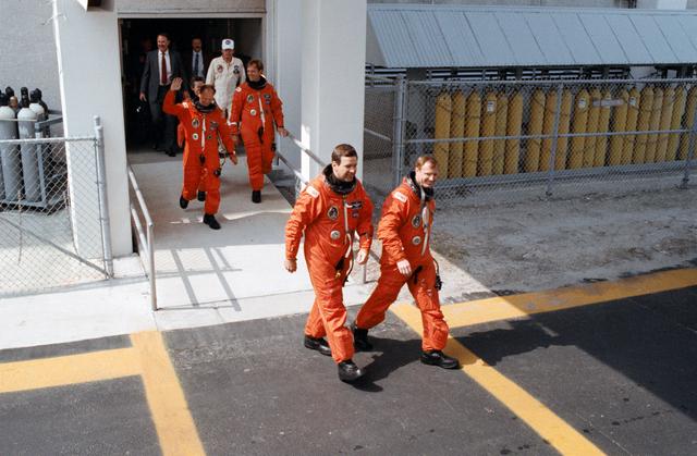 NASA image: STS-30 crewmembers leave KSC O&C Bldg during launch preparations