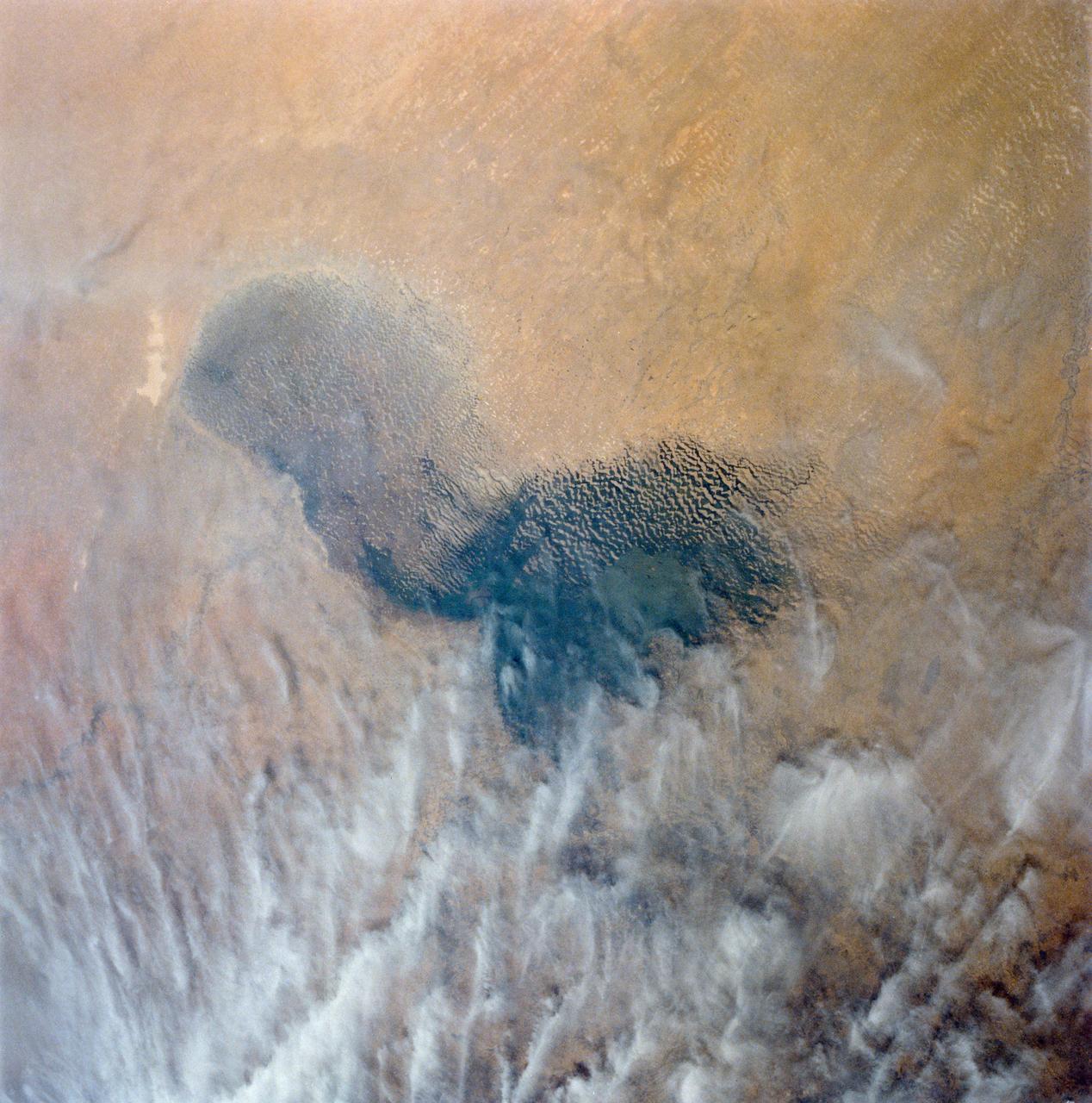 Africa's Lake Chad where the borders of Chad, Niger, Nigeria and Cameroon merge (13.0N, 14.0E) has been undergoing change for the past 25 to 30 years when it was first noticed that the lake is drying up. Since then, astronauts have been photographing it on a regular basis to record the diminishing lake bed. This lake was once the aproximate size of Lake Erie but is now only about half that size and is still receeding.