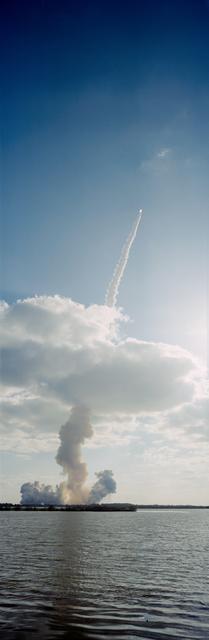 NASA image: STS-31 Discovery, OV-103, rockets through low-lying clouds after KSC liftoff